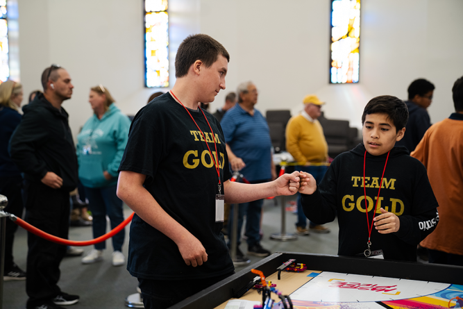 Teammates from Team Gold from Ridgecrest Adventist Elementary encourage each other before their next round begins.